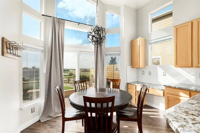 a view of a dining room with furniture and a window