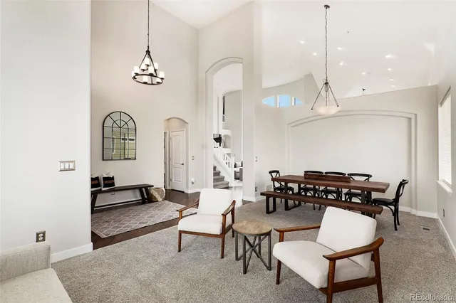 a living room with furniture a rug and white walls