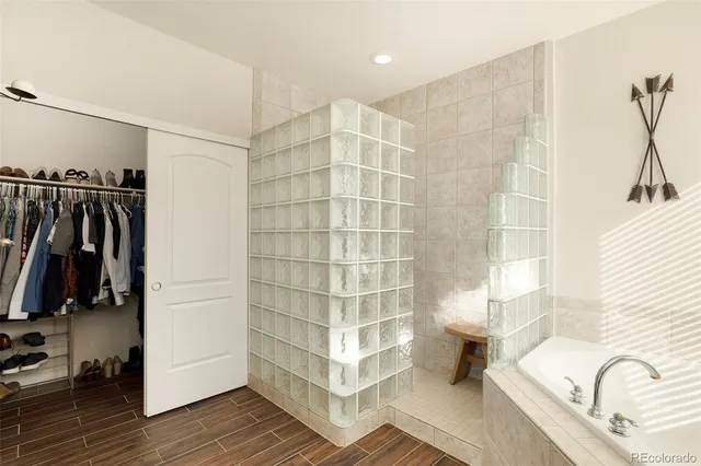 a bathroom with a bathtub and a shower