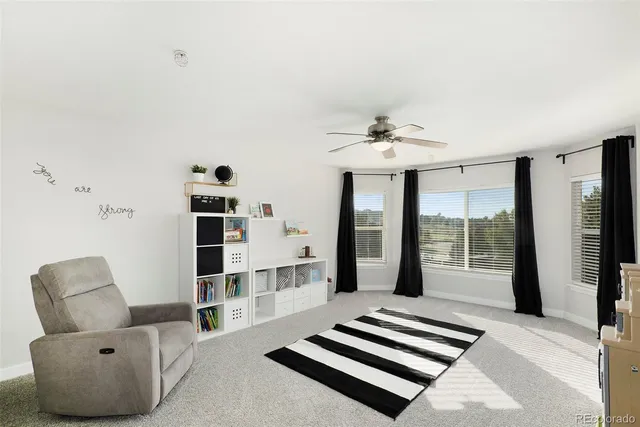 a living room with furniture and a floor to ceiling window