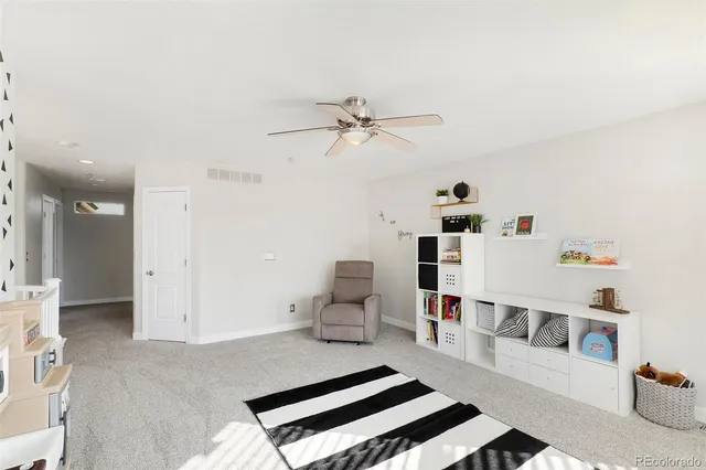 a living room with furniture and white walls