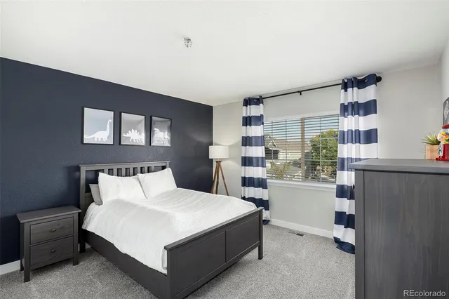 a bedroom with a large bed and a window