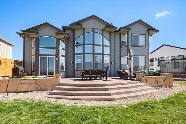 a view of a swimming pool and outdoor seating