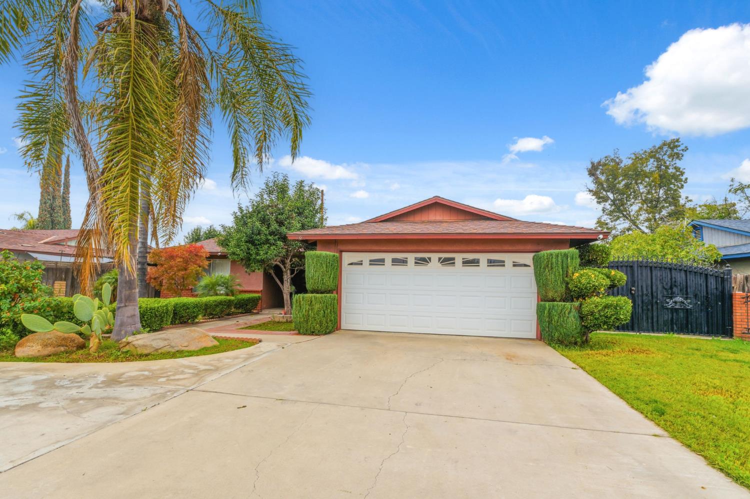 204 West Cesar Chavez Boulevard Fresno, CA 93706 - Photo 3 of 28 a front view of a house with a yard and garage