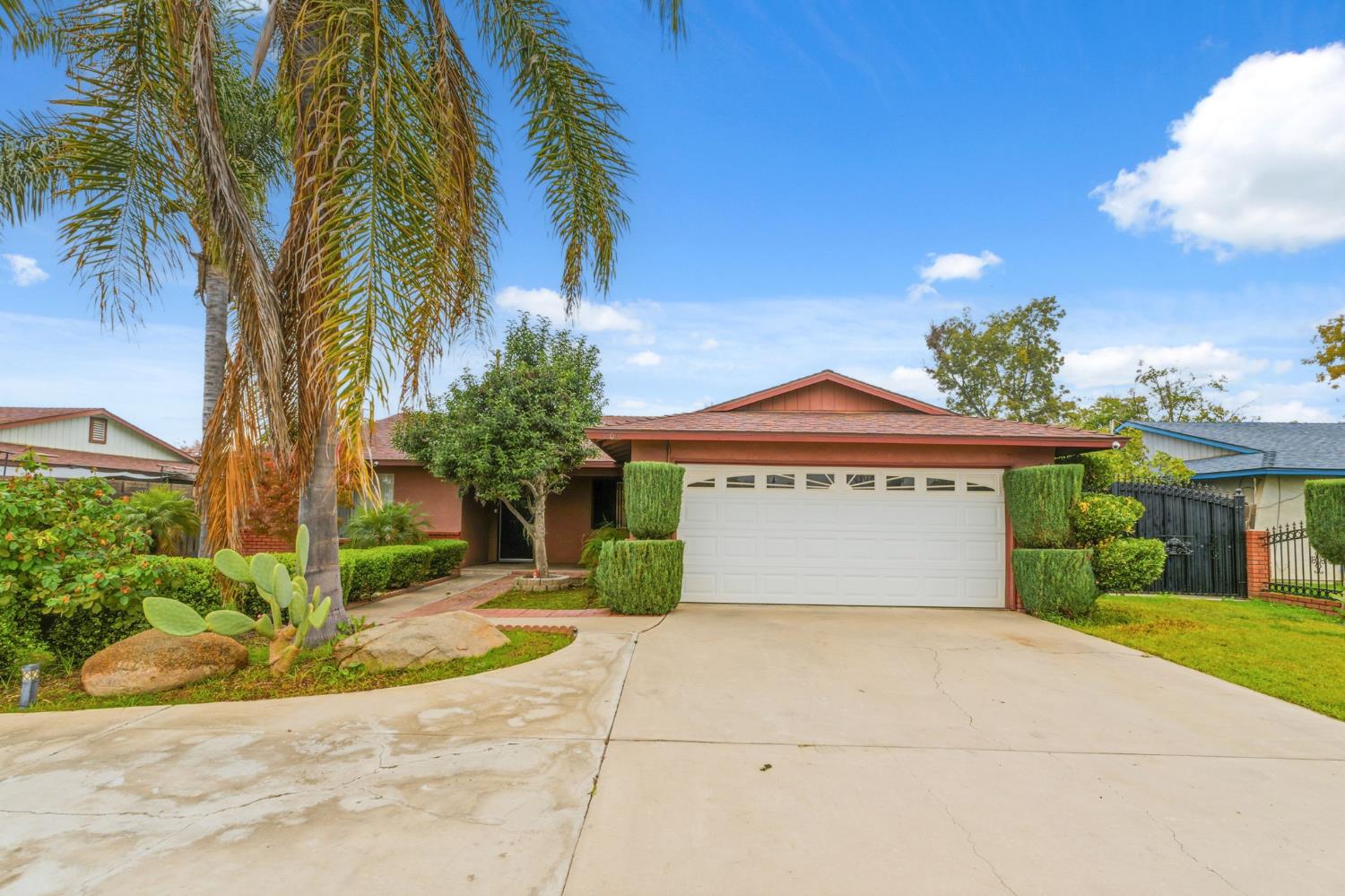 204 West Cesar Chavez Boulevard Fresno, CA 93706 - Photo 6 of 28 a front view of a house with a yard and potted plants