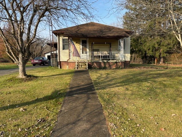 9517 Brick Church Road Cambridge, OH 43725 - Photo 1 of 26 Bungalow-style home featuring a porch and a front yard
