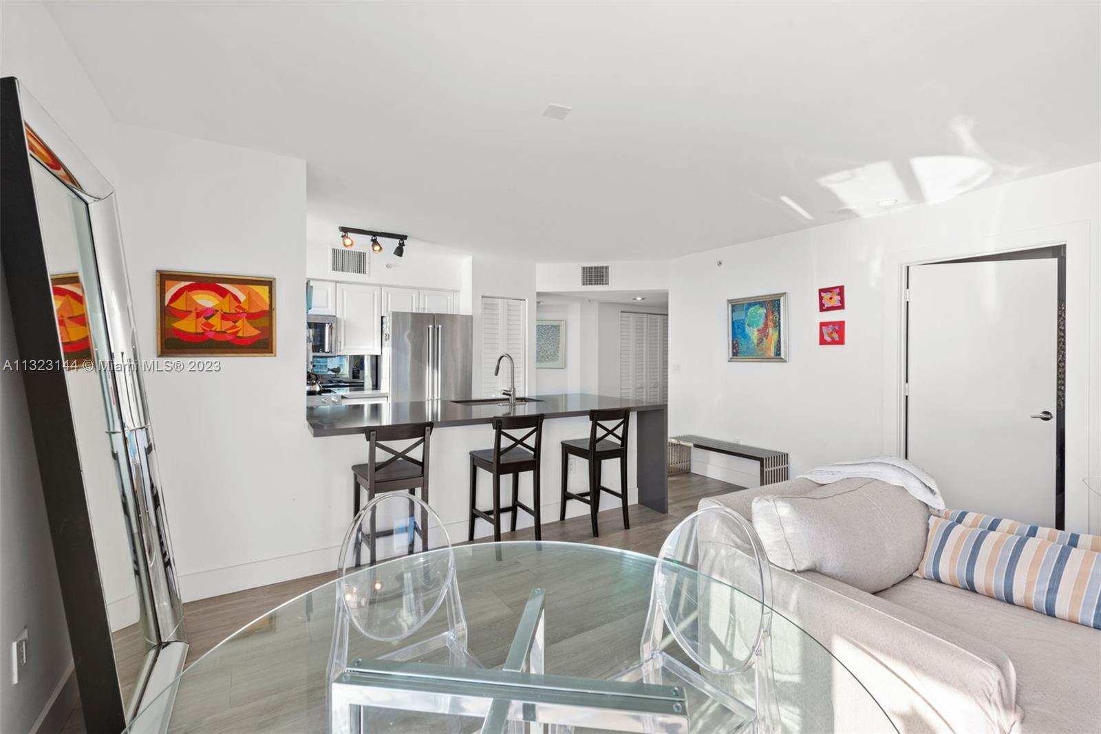 90 Alton Road, Unit 1602 Miami Beach, FL 33139 - Photo 14 of 34 a living room with furniture and a table