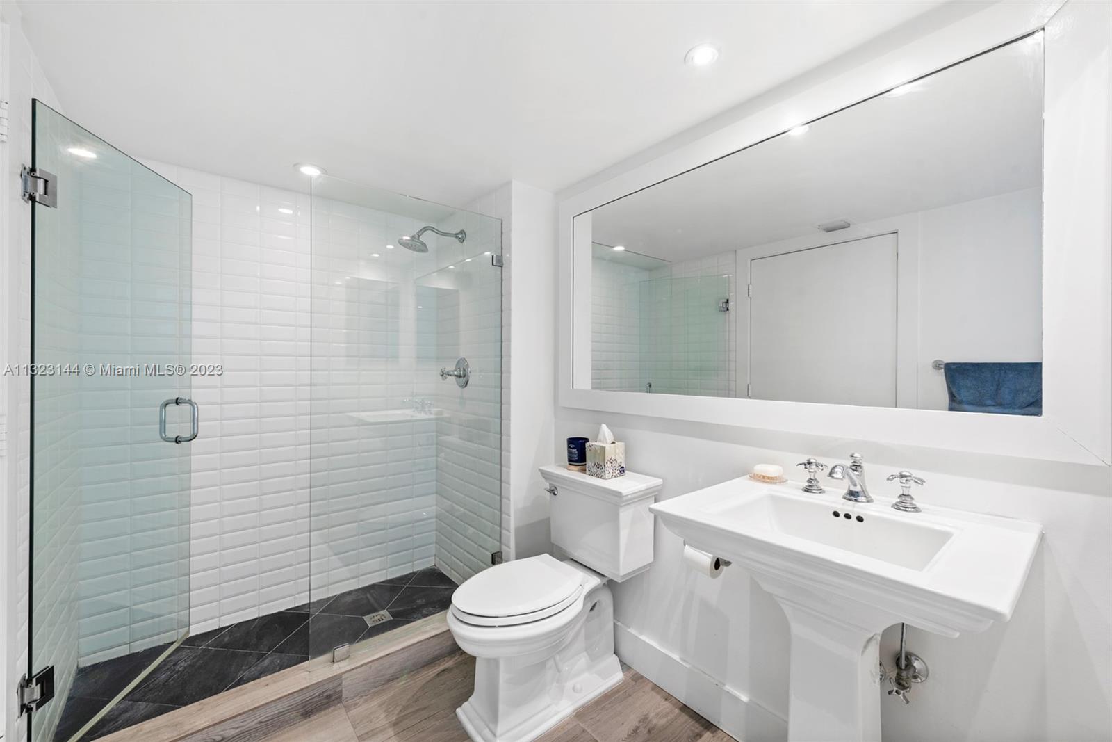 90 Alton Road, Unit 1602 Miami Beach, FL 33139 - Photo 22 of 34 a bathroom with a sink a toilet and shower