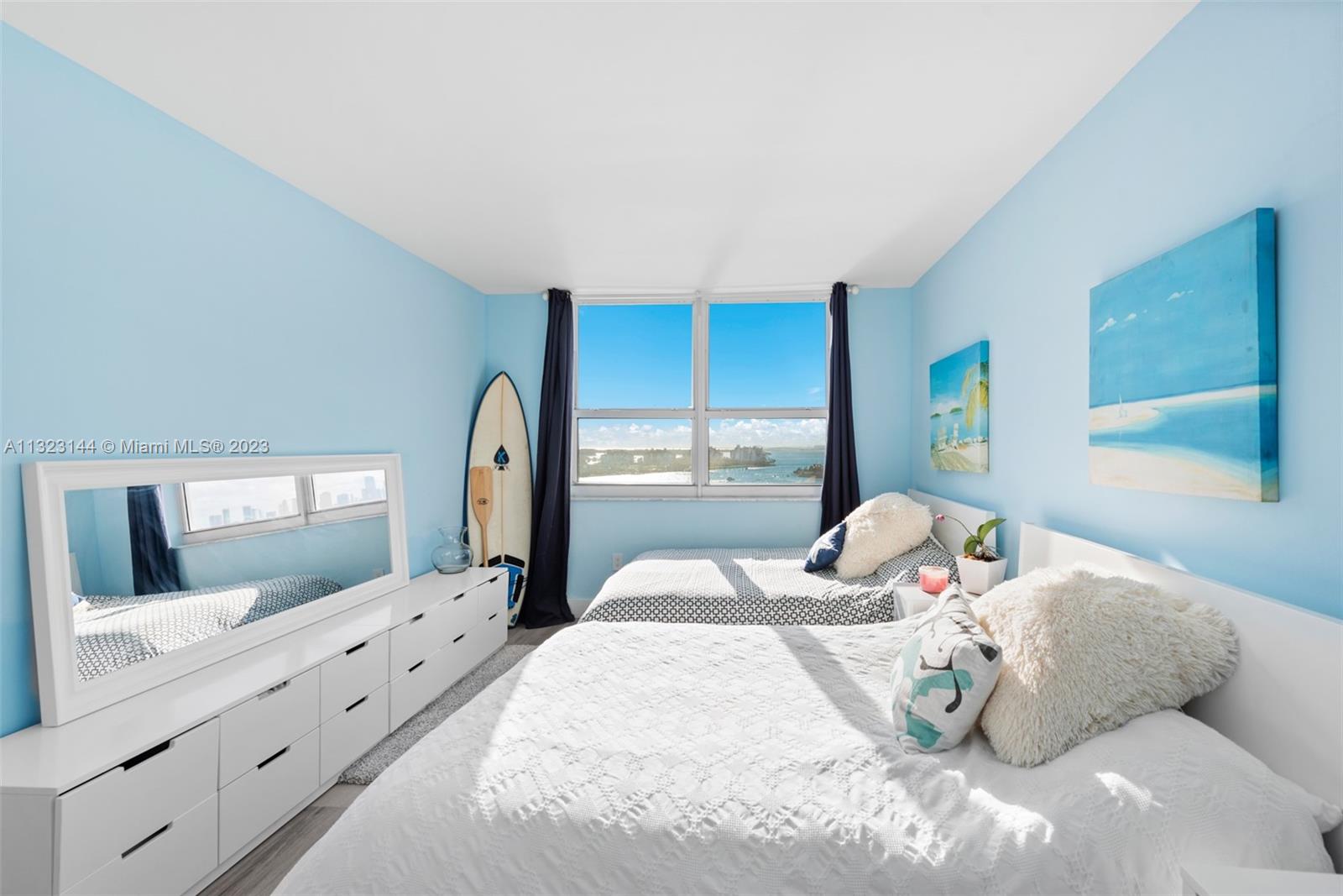 90 Alton Road, Unit 1602 Miami Beach, FL 33139 - Photo 24 of 34 a bedroom with a large bed and a mirror