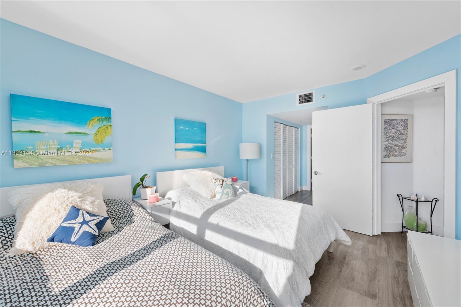 90 Alton Road, Unit 1602 Miami Beach, FL 33139 - Photo 25 of 34 a bedroom with bed and a couch