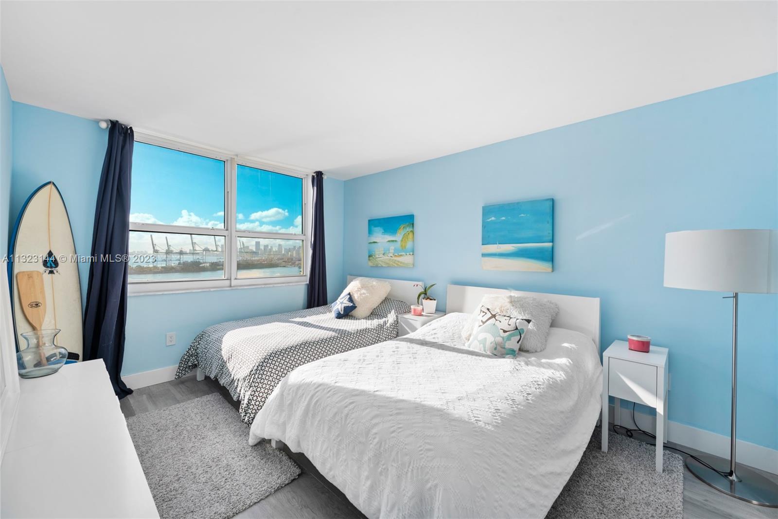 90 Alton Road, Unit 1602 Miami Beach, FL 33139 - Photo 26 of 34 a bedroom with a bed a mirror and a large window