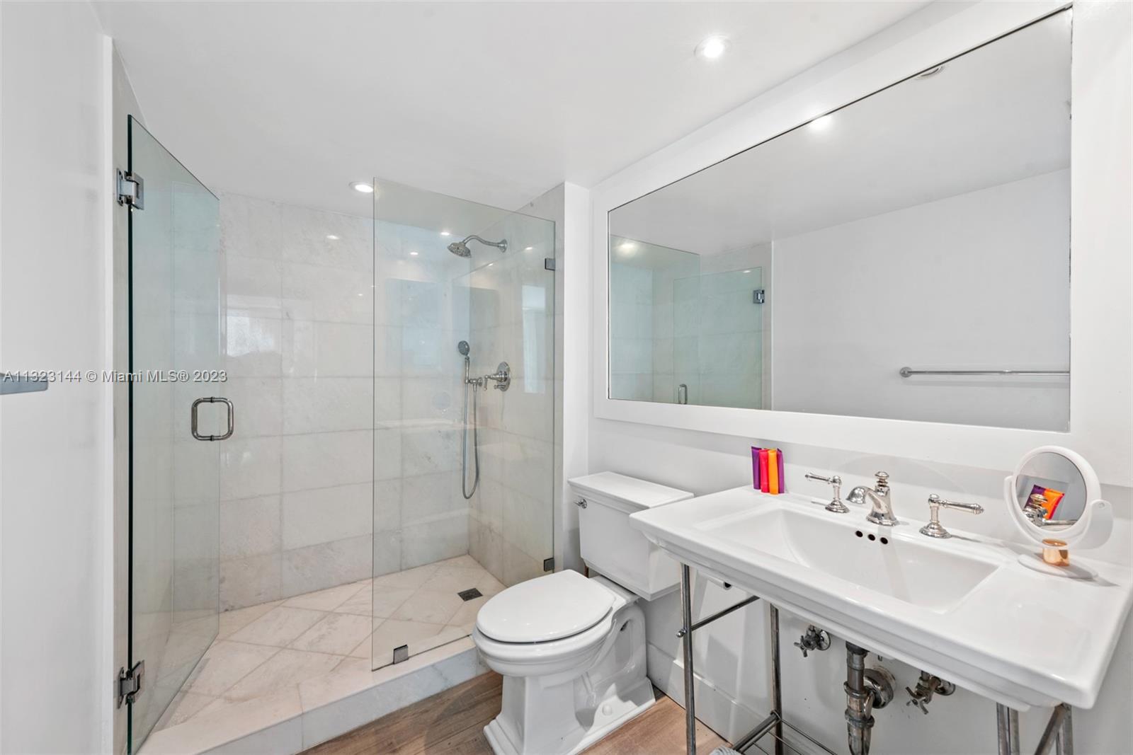 90 Alton Road, Unit 1602 Miami Beach, FL 33139 - Photo 27 of 34 a bathroom with a sink toilet and shower