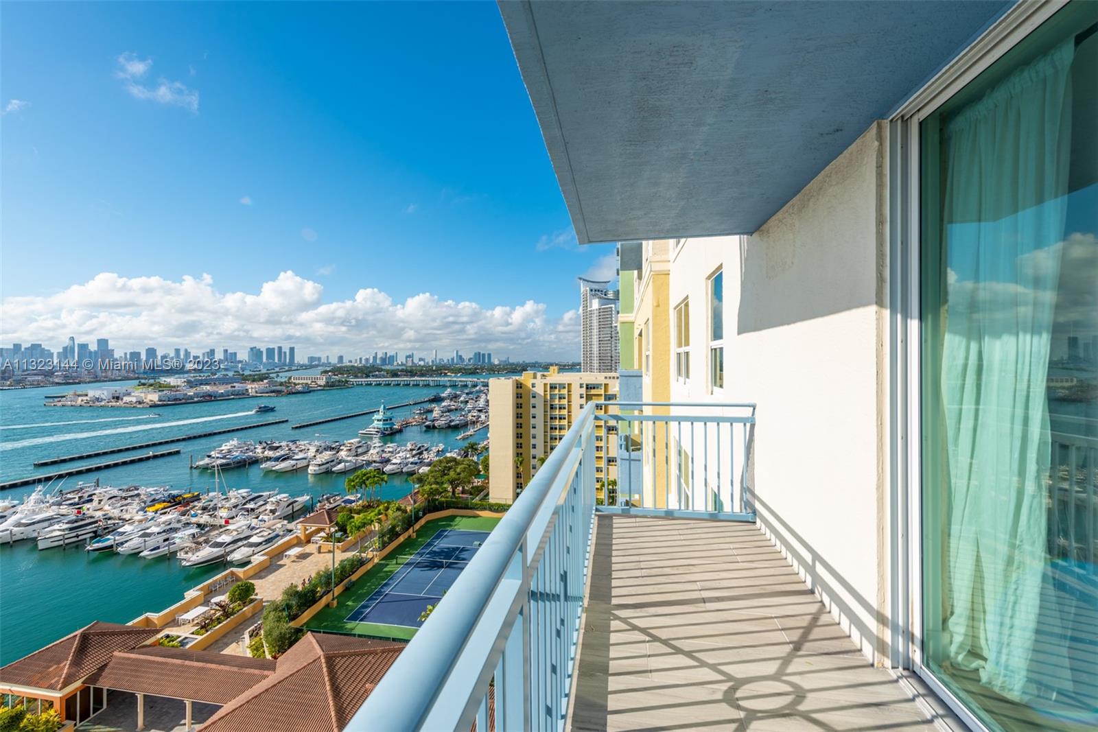 90 Alton Road, Unit 1602 Miami Beach, FL 33139 - Photo 4 of 34 a view of a balcony with lake view and wooden floor