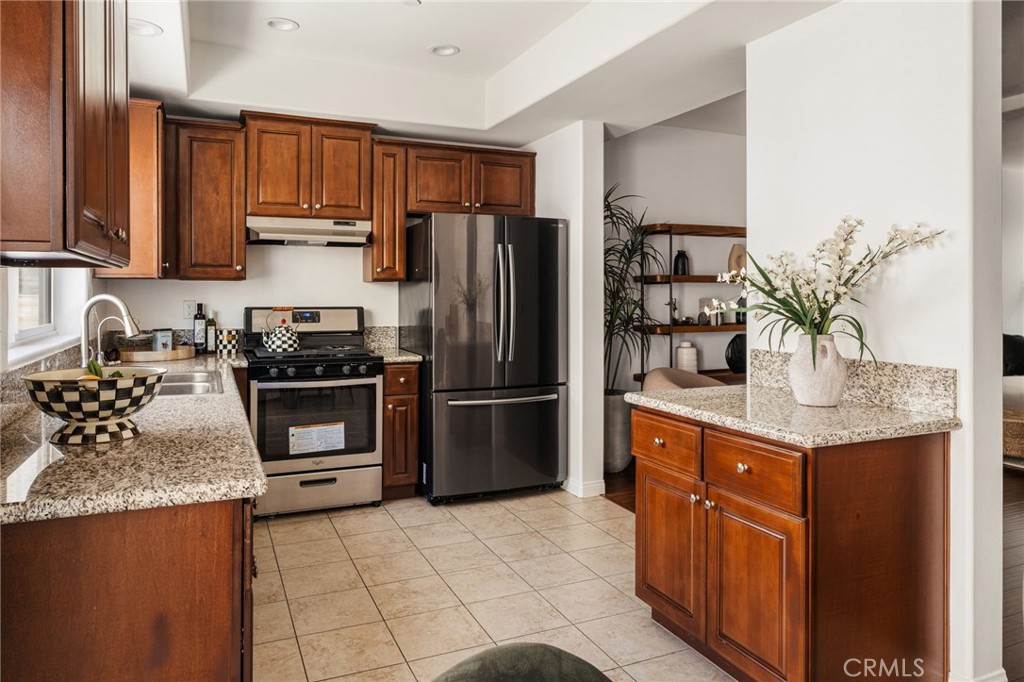 4612 Peck Road, Unit D El Monte, CA 91732 - Photo 14 of 57 a kitchen with stainless steel appliances granite countertop a refrigerator a stove a sink and a counter space