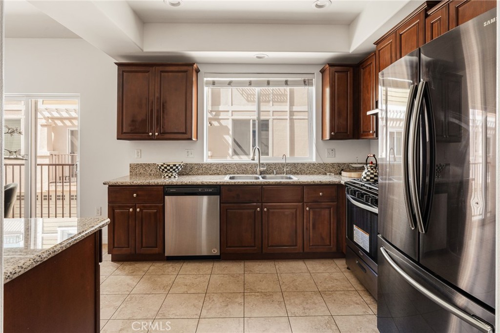 4612 Peck Road, Unit D El Monte, CA 91732 - Photo 15 of 57 a kitchen with stainless steel appliances granite countertop a refrigerator and a sink