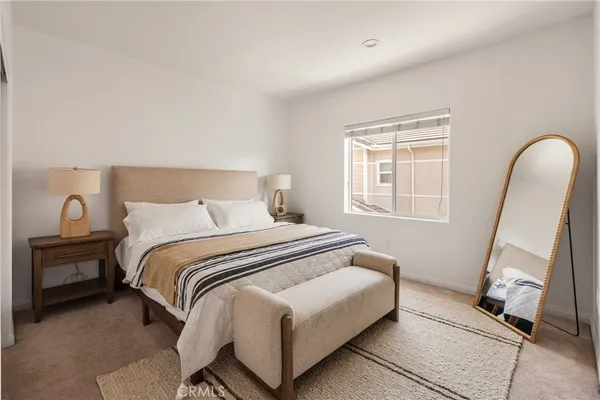 a bedroom with a bed and a mirror