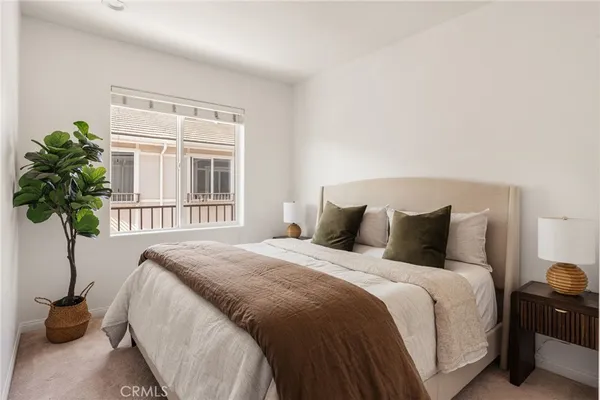 a bedroom with a bed and window