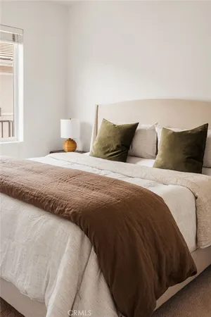 a bedroom with a bed plant and a window