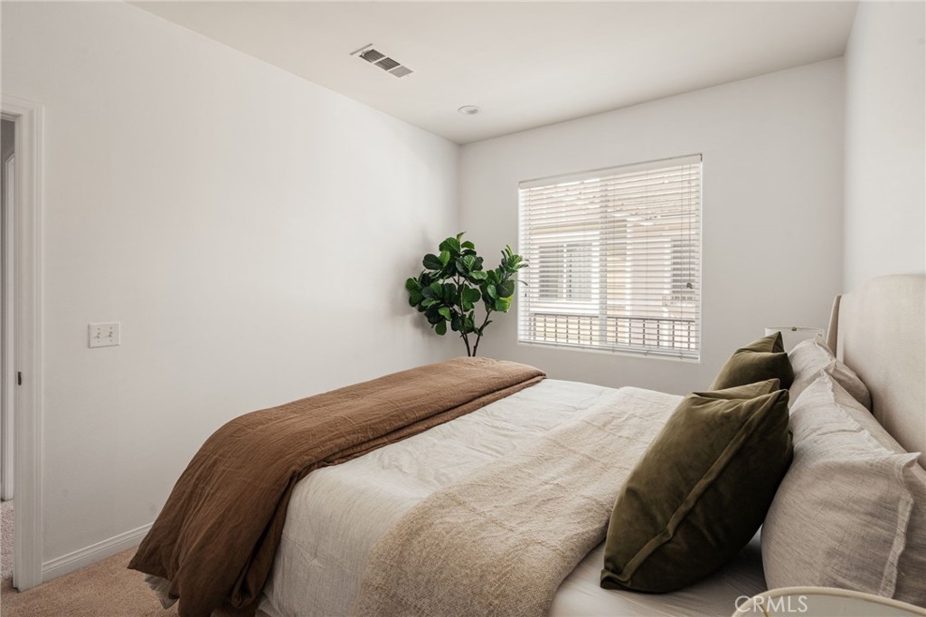 4612 Peck Road, Unit D El Monte, CA 91732 - Photo 29 of 57 a bedroom with a bed plant and a window