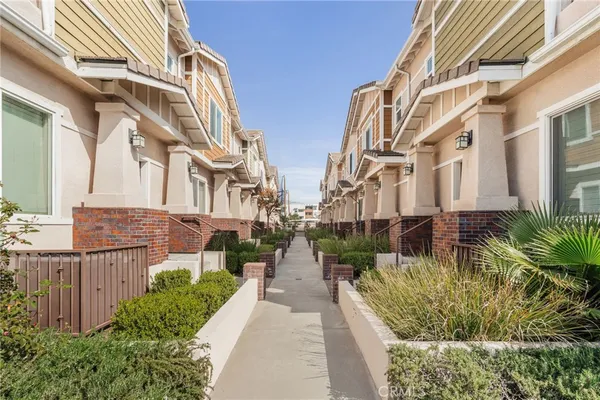 a view of a pathway both side of house
