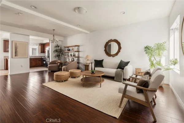 a living room with furniture and a chandelier