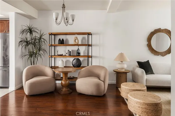 a living room with furniture fireplace and a large window