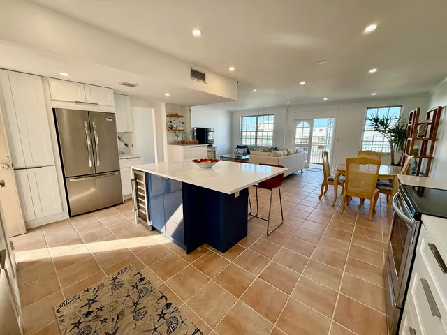 a bedroom with a bed a flat screen tv and a window