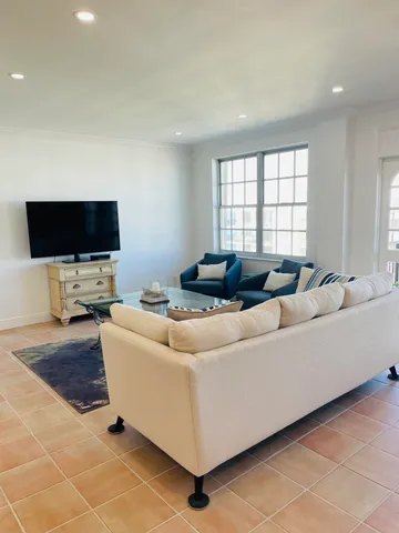 a living room with stainless steel appliances kitchen island granite countertop furniture and a kitchen view