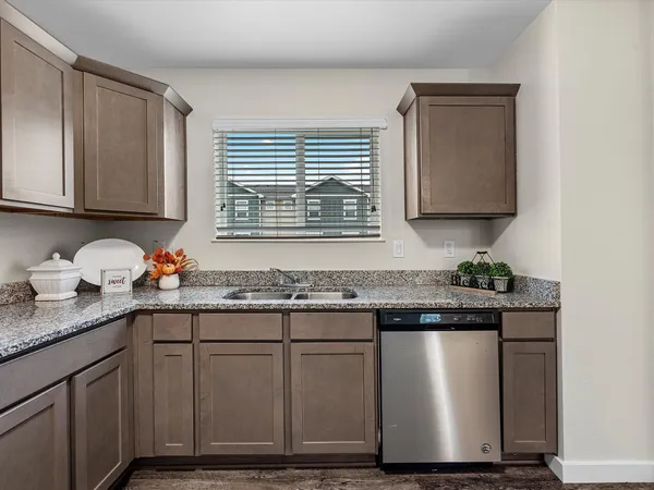 a kitchen with granite countertop a sink and a stove