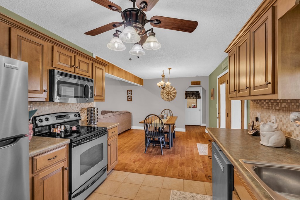 465 Hickory Lane Sparta, TN 38583 - Photo 28 of 46 a kitchen with stainless steel appliances granite countertop a sink a stove and a refrigerator