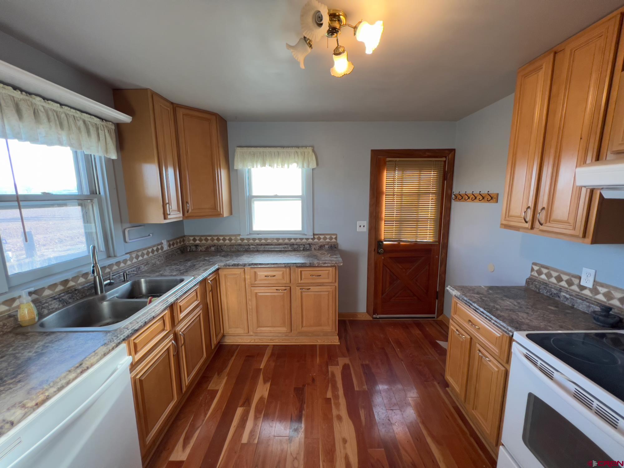 8139 5600th Road Olathe, CO 81425 - Photo 13 of 30 a kitchen with granite countertop wooden floors granite counter tops and a window