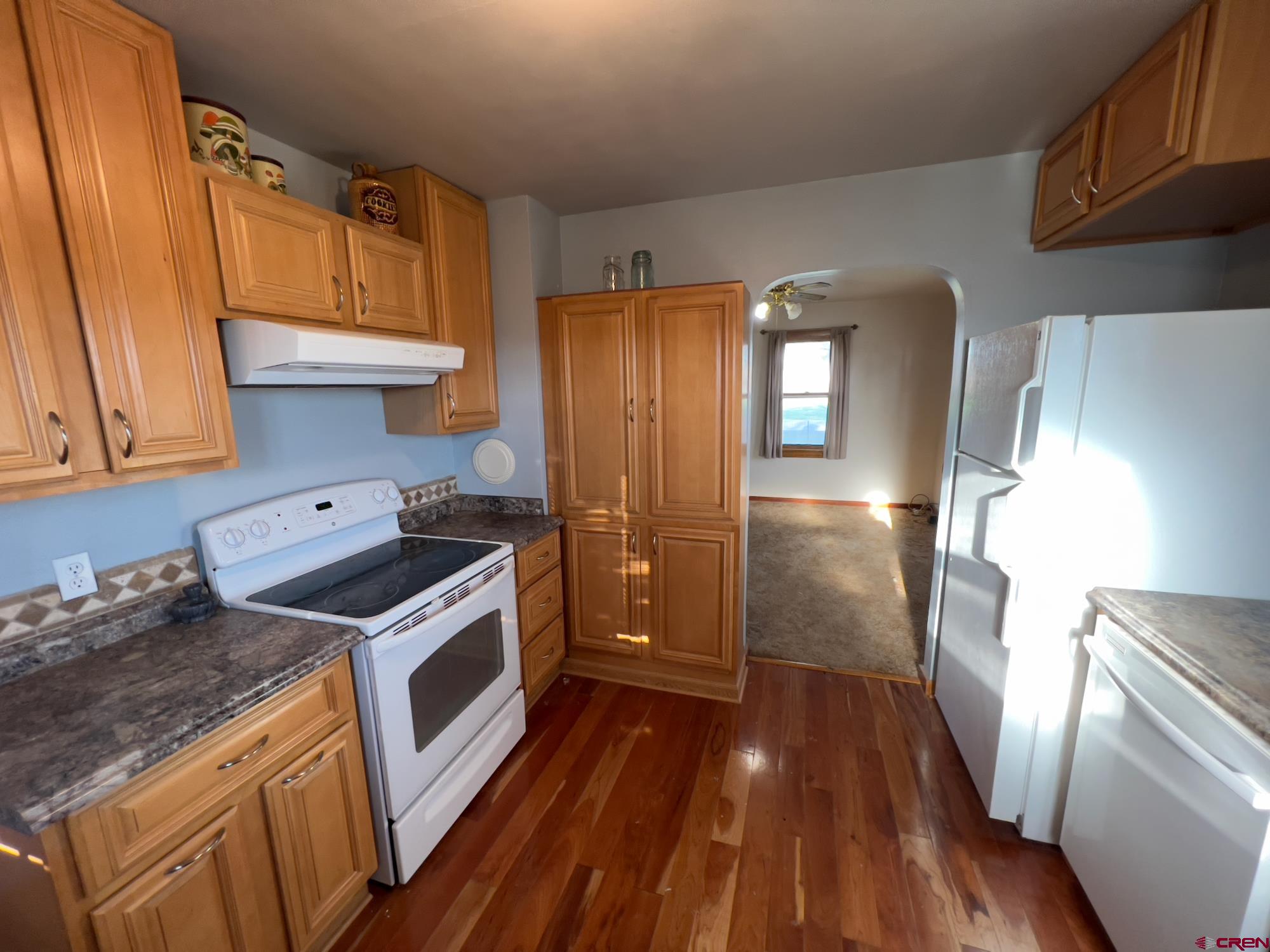 8139 5600th Road Olathe, CO 81425 - Photo 15 of 30 a kitchen with a stove a refrigerator and a cabinets