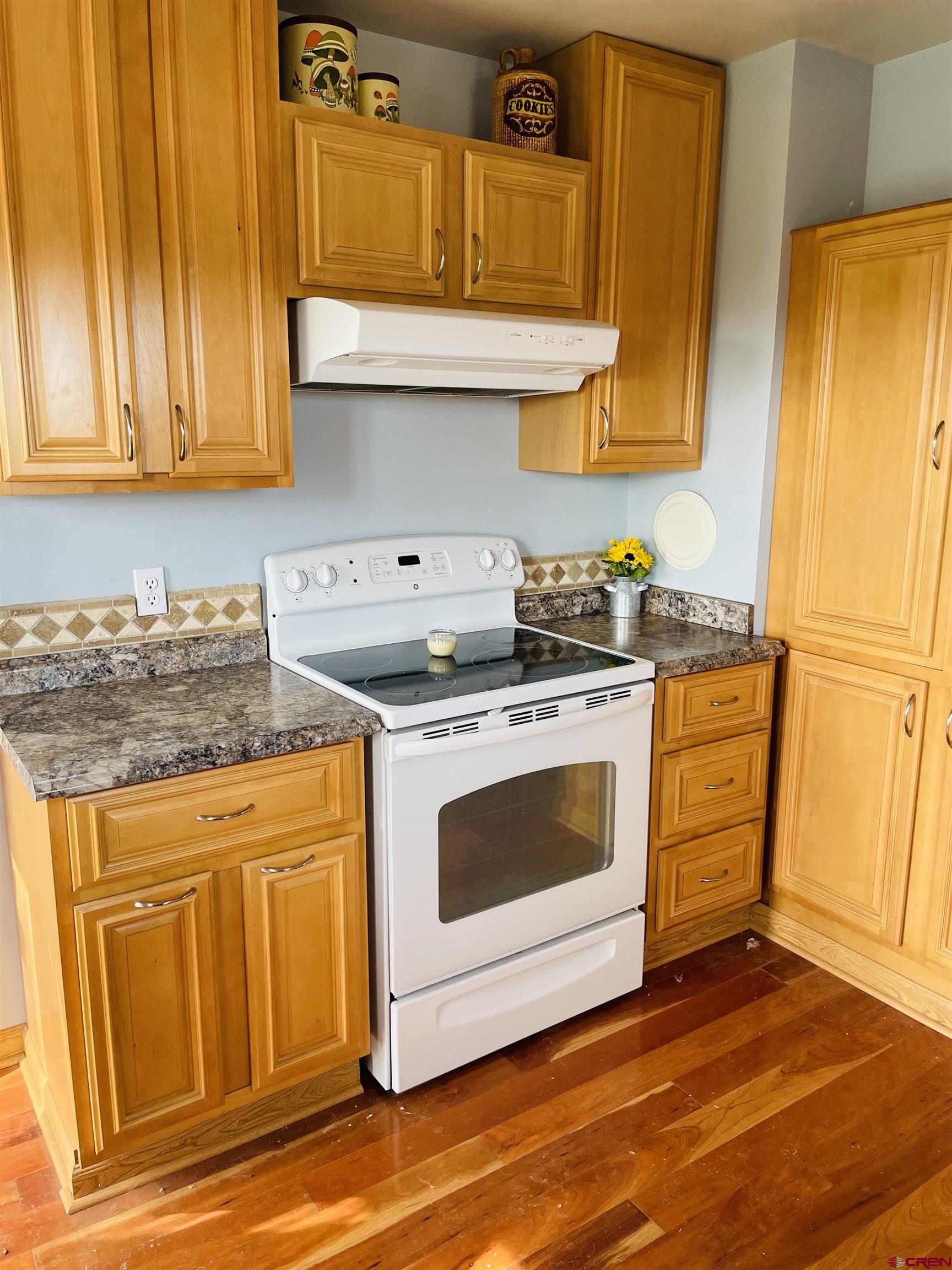 8139 5600th Road Olathe, CO 81425 - Photo 27 of 30 a kitchen with stainless steel appliances granite countertop a stove a sink and a microwave