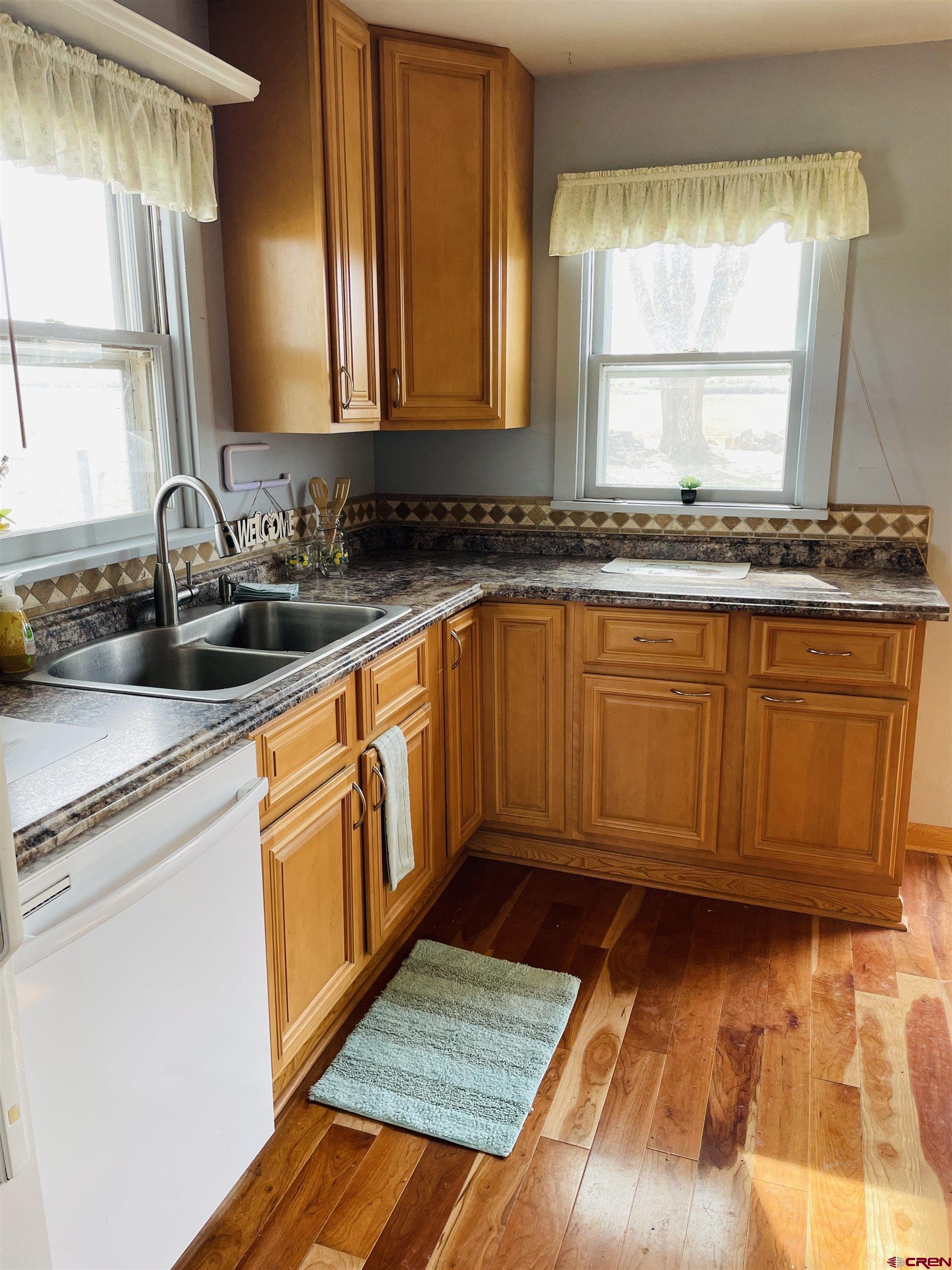 8139 5600th Road Olathe, CO 81425 - Photo 28 of 30 a kitchen with sink window and cabinets