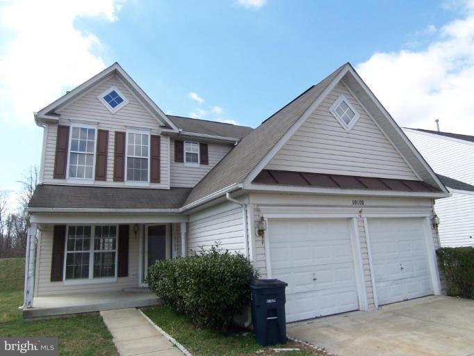 10102 Summershade Lane Springdale, MD 20721 - Photo 1 of 12 a front view of a house with garage