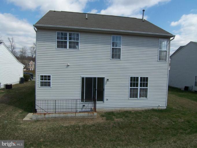 10102 Summershade Lane Springdale, MD 20721 - Photo 2 of 12 a front view of a house with a yard