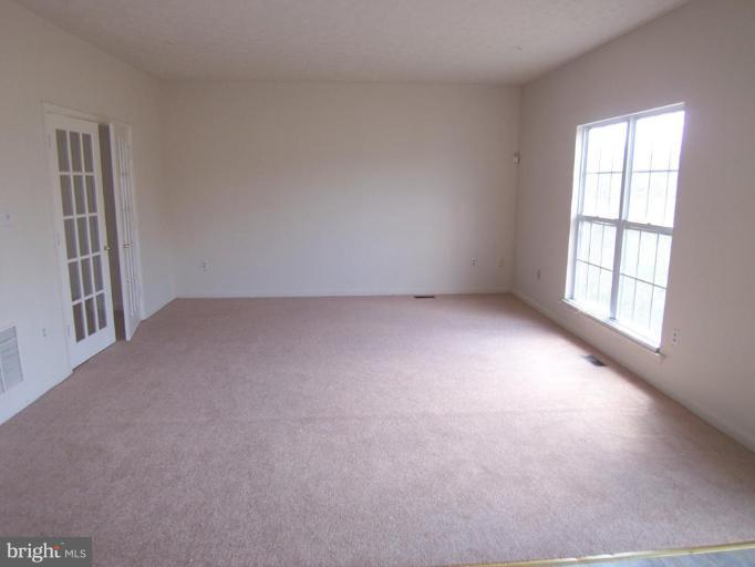10102 Summershade Lane Springdale, MD 20721 - Photo 5 of 12 an empty room with windows