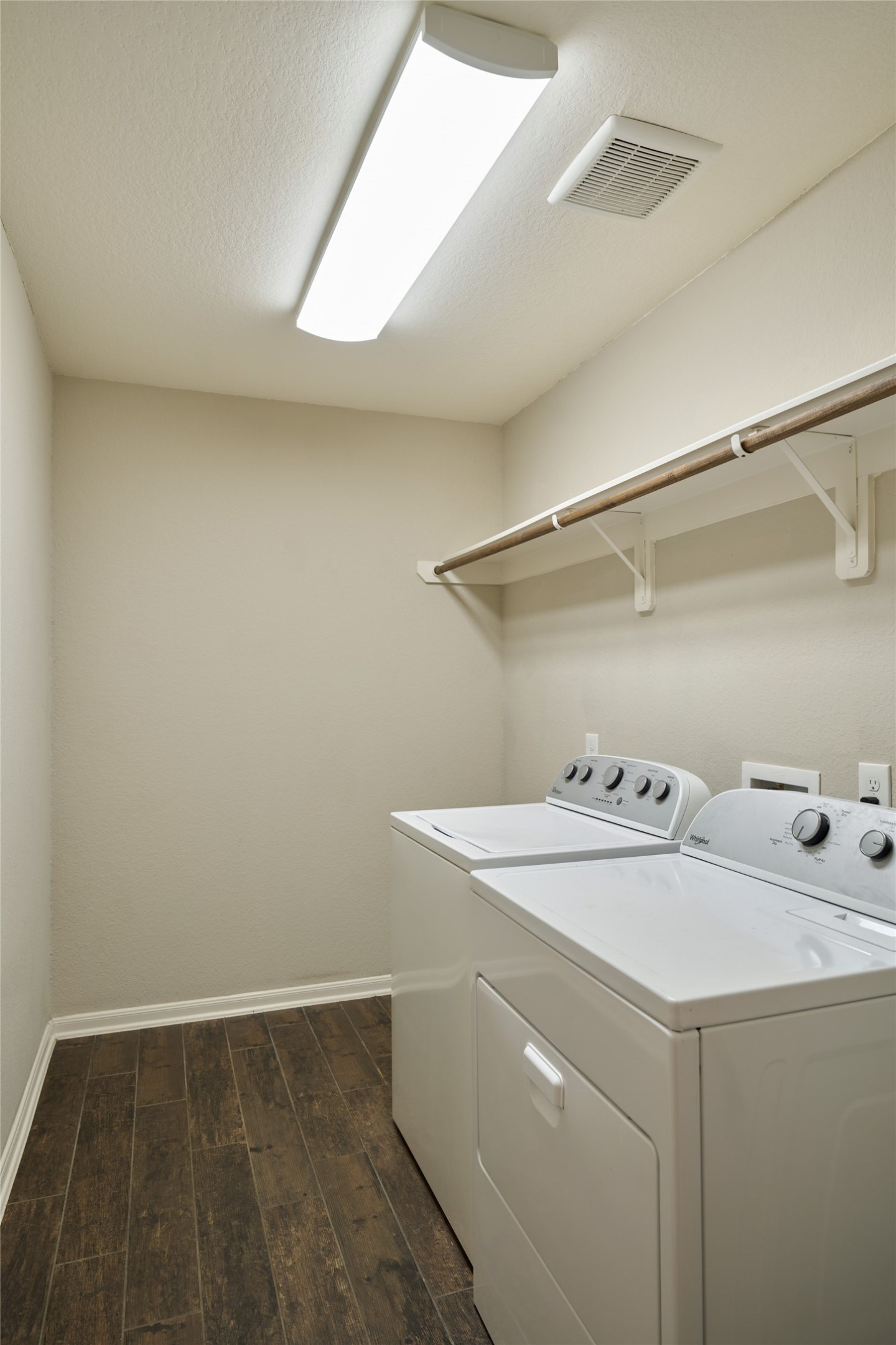 116 Fox Trail Road Montgomery, TX 77316 - Photo 24 of 50 Laundry room with a washer and dryer (included) with overhead shelving, and wood-look tile flooring.