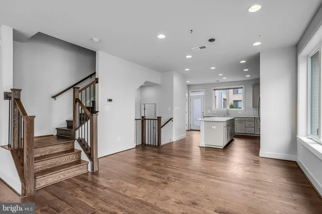 a view of an empty room with a window and fireplace