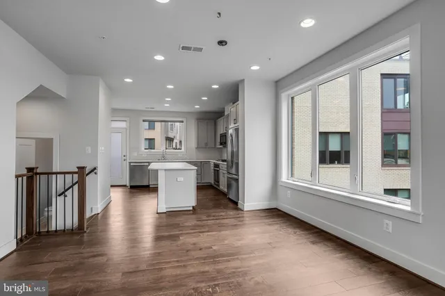 a view of a livingroom with wooden floor and a fireplace