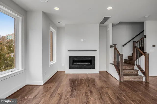 a view of an entryway with wooden floor and windows