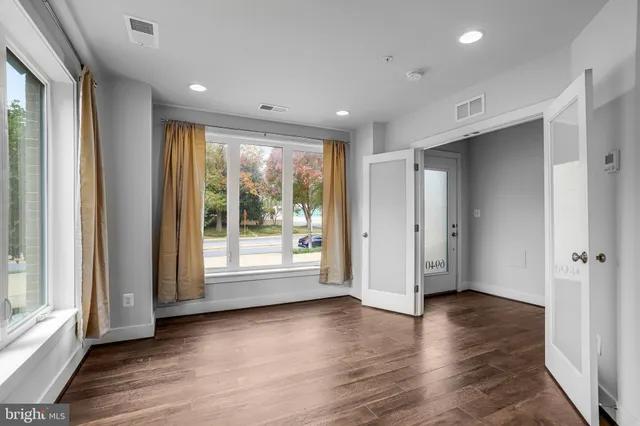 a view of livingroom with furniture wooden floor and windows