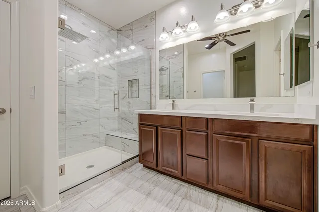 a bathroom with a sink a double vanity and a mirror