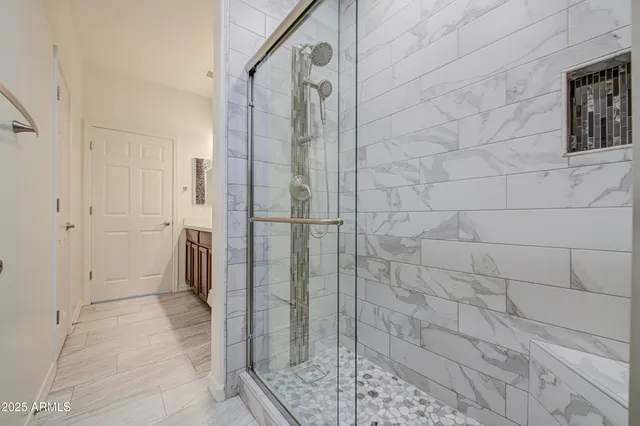 a bathroom with a shower and a sink