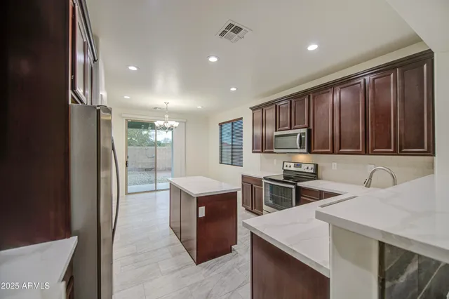 a kitchen that has a sink and a stove in it