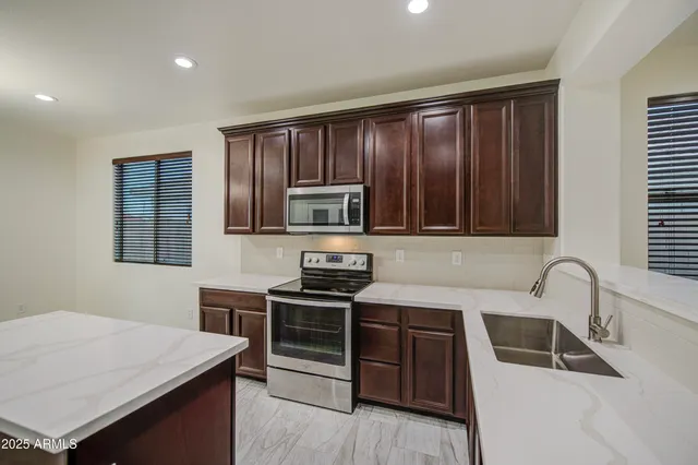 a kitchen with a sink and a refrigerator