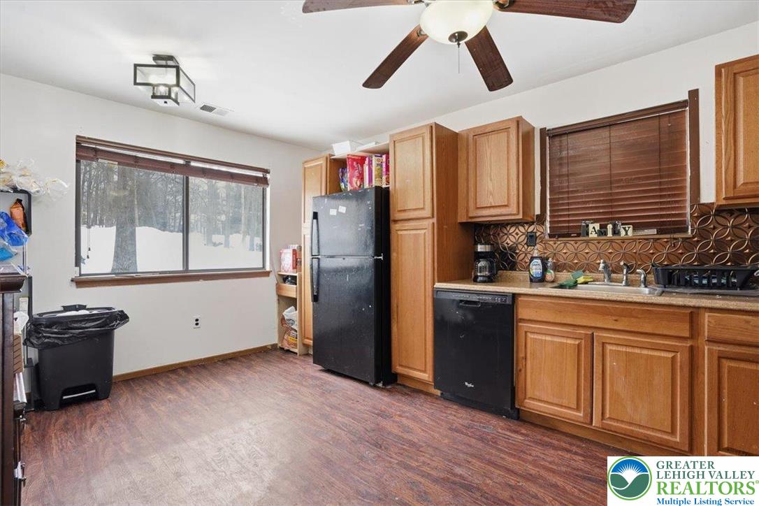 3301 Windermere Drive Bushkill, PA 18324 - Photo 11 of 71 a kitchen with stainless steel appliances granite countertop a refrigerator a stove a sink and dishwasher with wooden floor