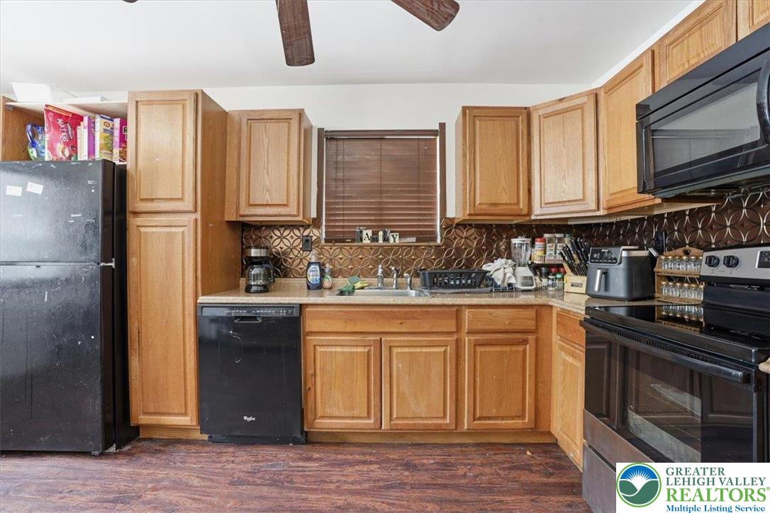 3301 Windermere Drive Bushkill, PA 18324 - Photo 14 of 71 a kitchen with stainless steel appliances granite countertop a stove a sink dishwasher and a refrigerator with wooden cabinets