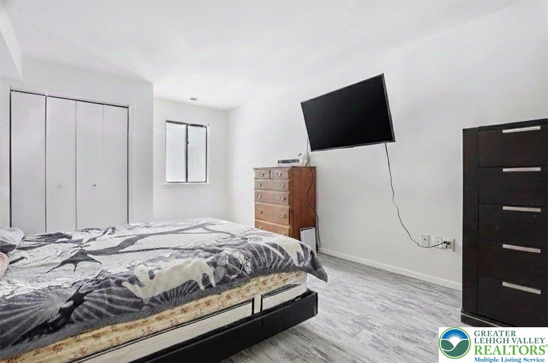 3301 Windermere Drive Bushkill, PA 18324 - Photo 18 of 71 a bedroom with a bed a flat screen tv and dresser