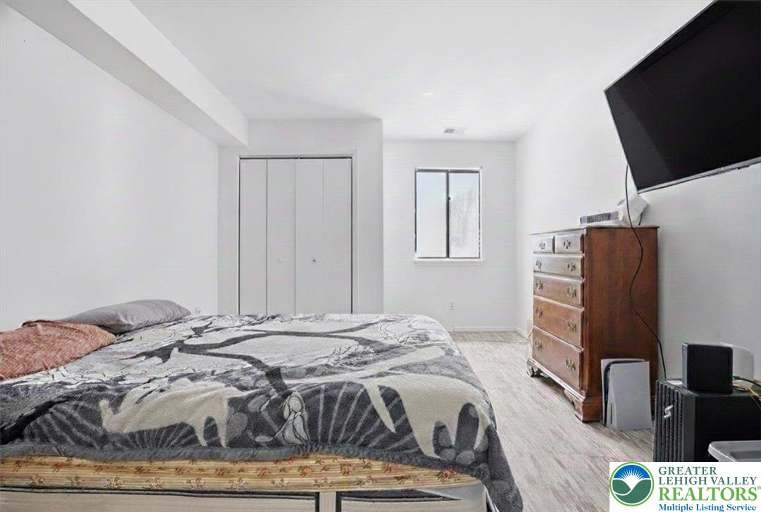 3301 Windermere Drive Bushkill, PA 18324 - Photo 19 of 71 a bedroom with a bed and flat screen tv